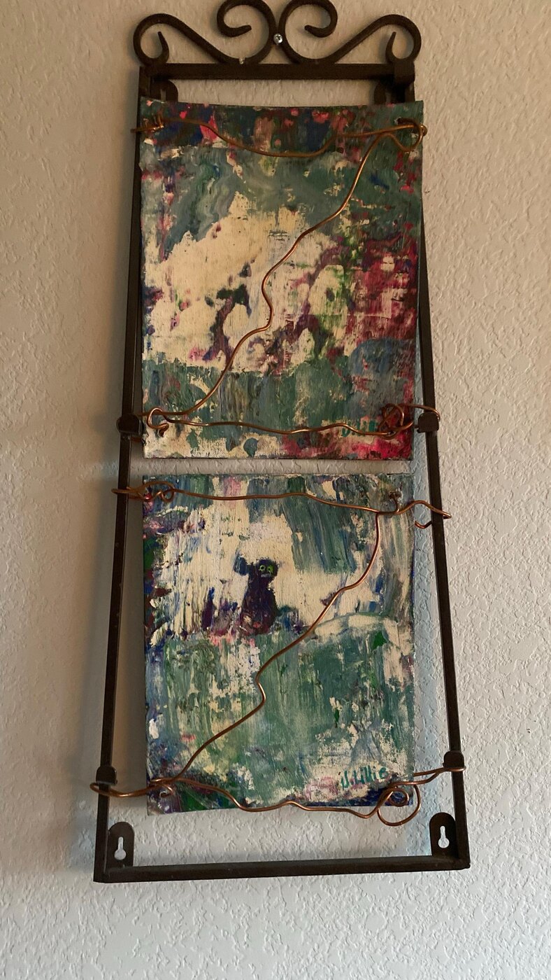 Painted wall art with copper wire on a metal frame