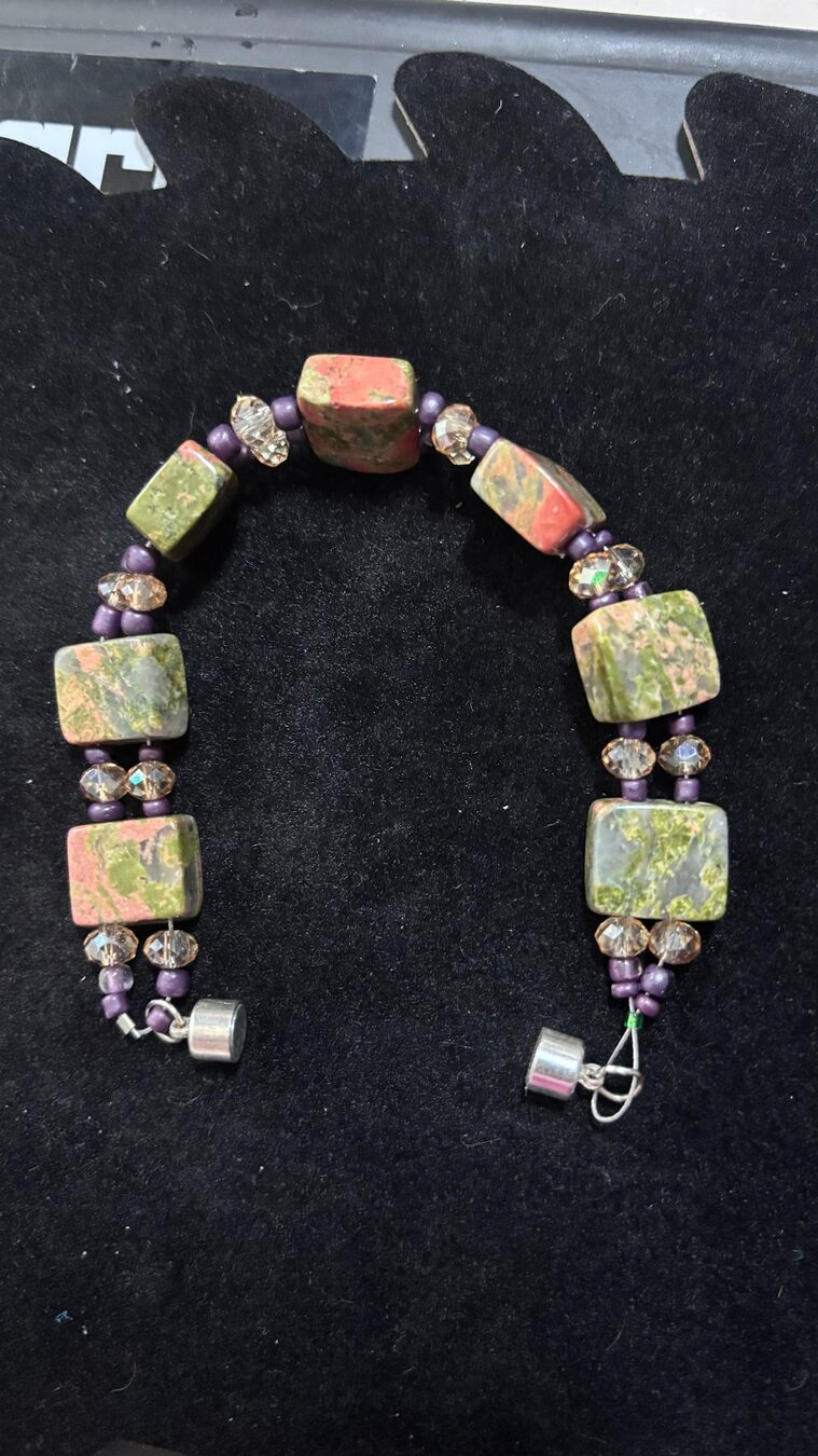 Handmade bracelet with dragon blood stone beads and purple accents