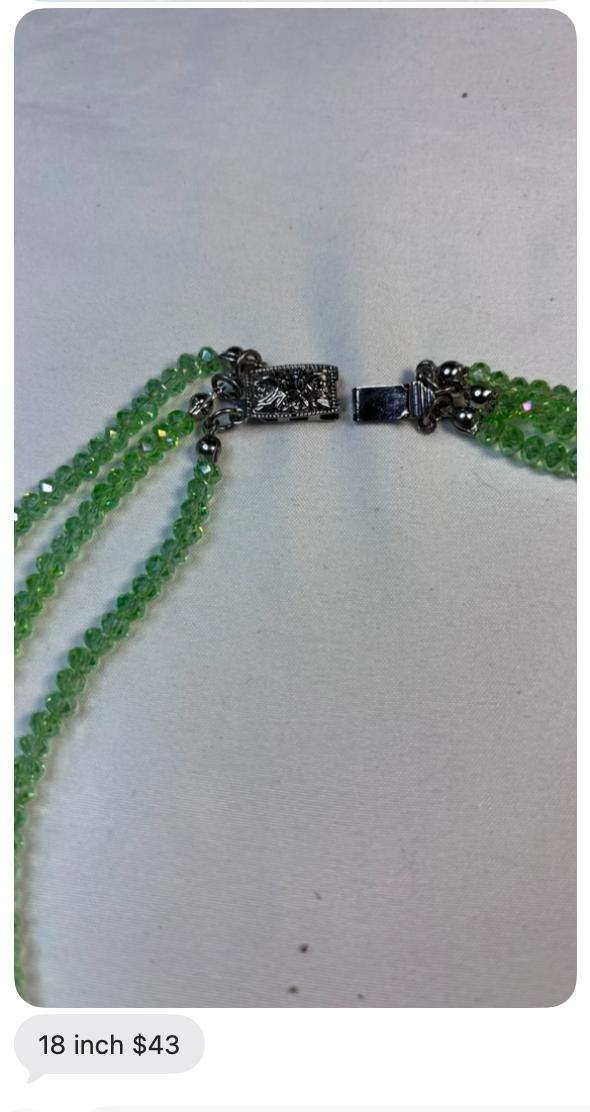 Close-up of the green beaded necklace clasp