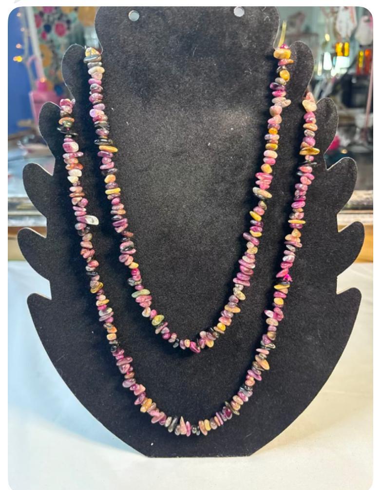 Multicolor chip 36 inch necklace on a black display bust