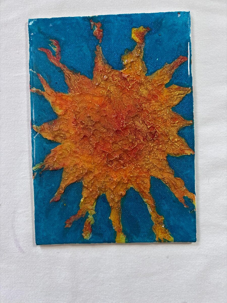 Orange sunburst painting on blue background