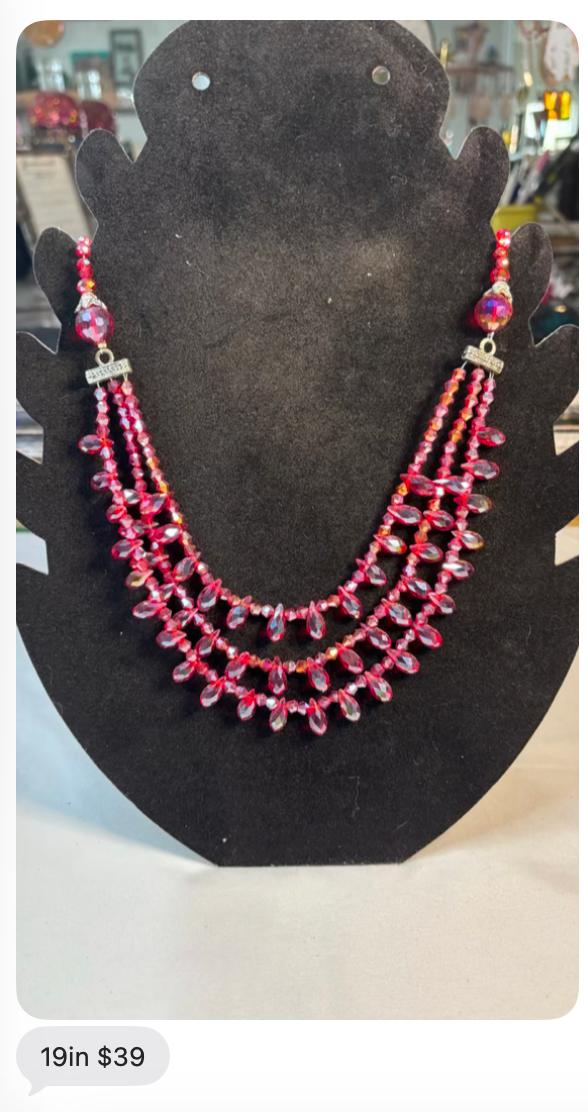 Red crystal 19 inch statement necklace on a black display bust