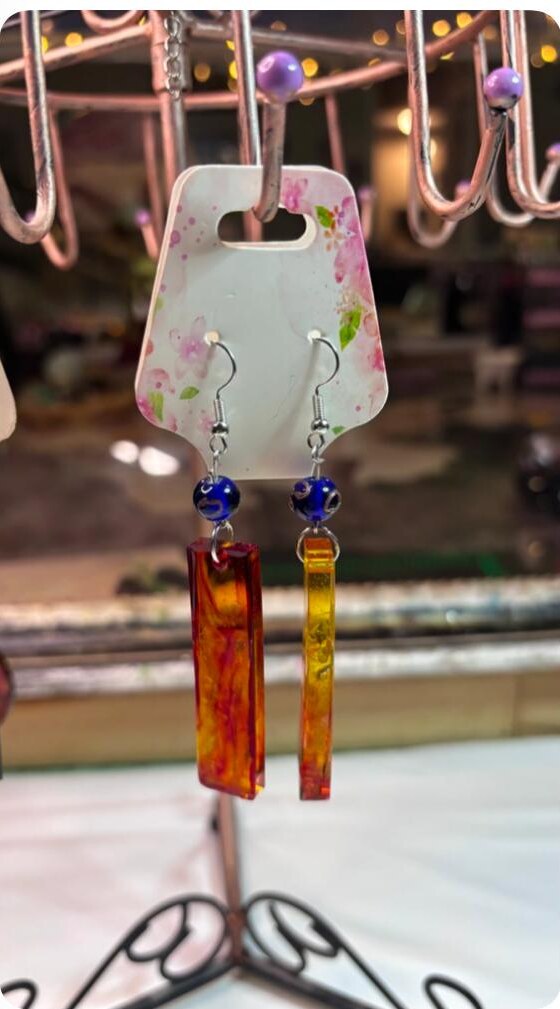 Amber orange rectangular handmade resin earrings with blue bead accents