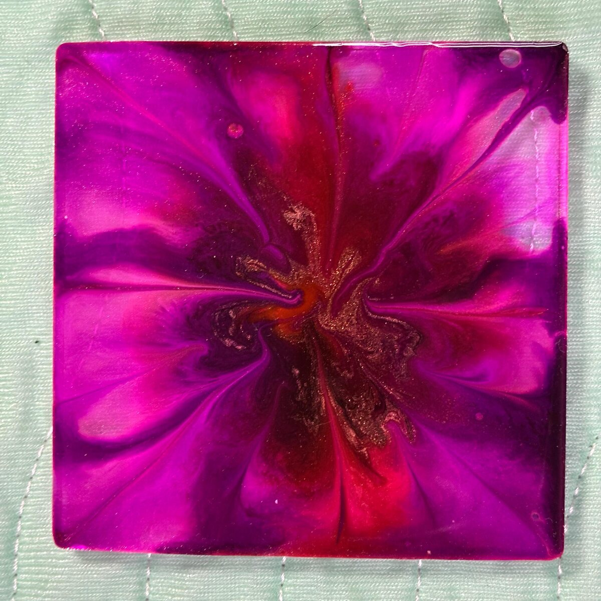 Magenta square resin coaster with floral swirl center
