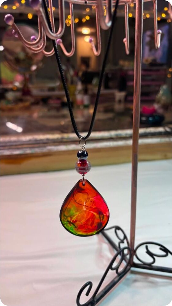 18 inch handmade rainbow teardrop resin necklace on a black cord