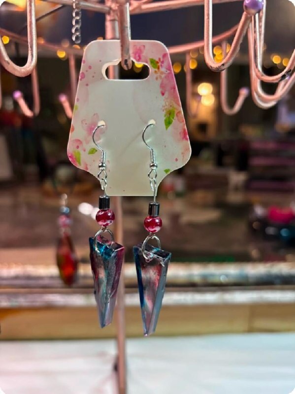 Teal and pink arrowhead style handmade resin earrings with red bead accents